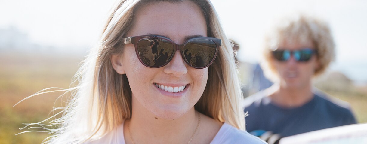a women smiling at the camera wearing Zeal Optics sunglasses