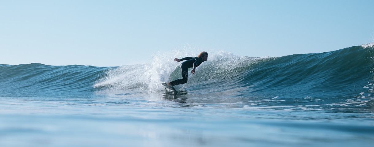 a man in a wetsuit surfing