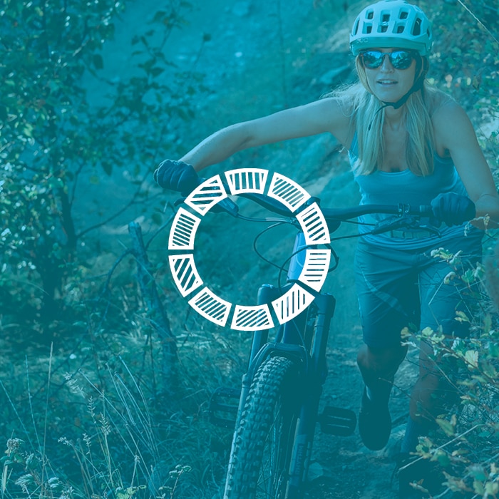 female mountain biker with blue filter over image and circle icon in the center
