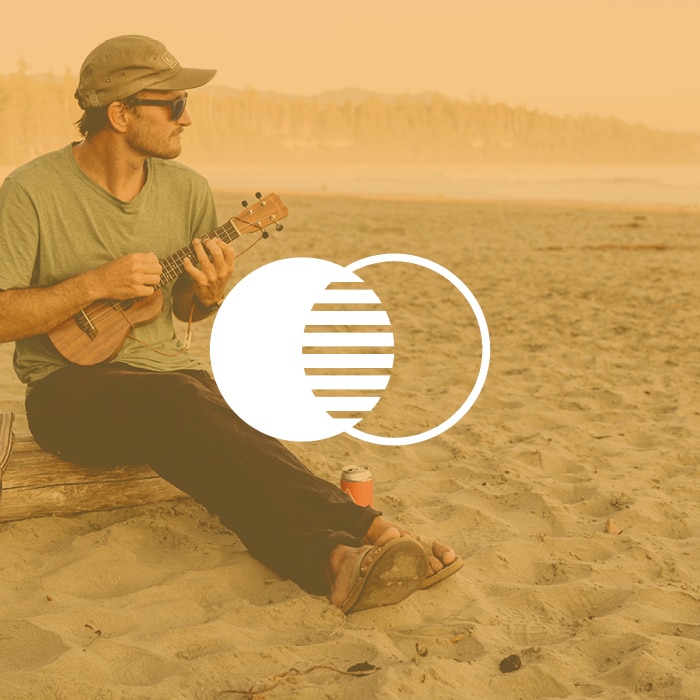 man on a beach with yellow filter over image and two centered circle icons