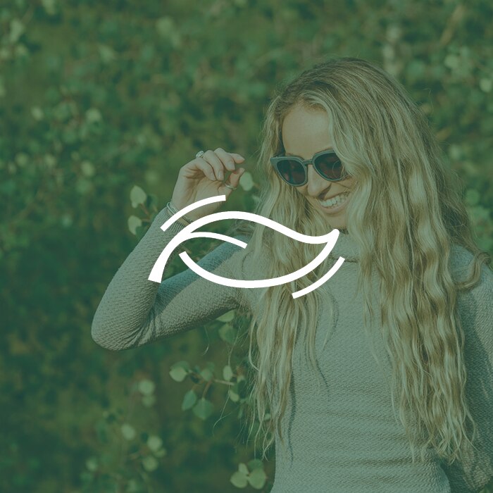 zeal optics plant based clarity icon - woman wearing zeal sunglasses with leaf icon overlaid
