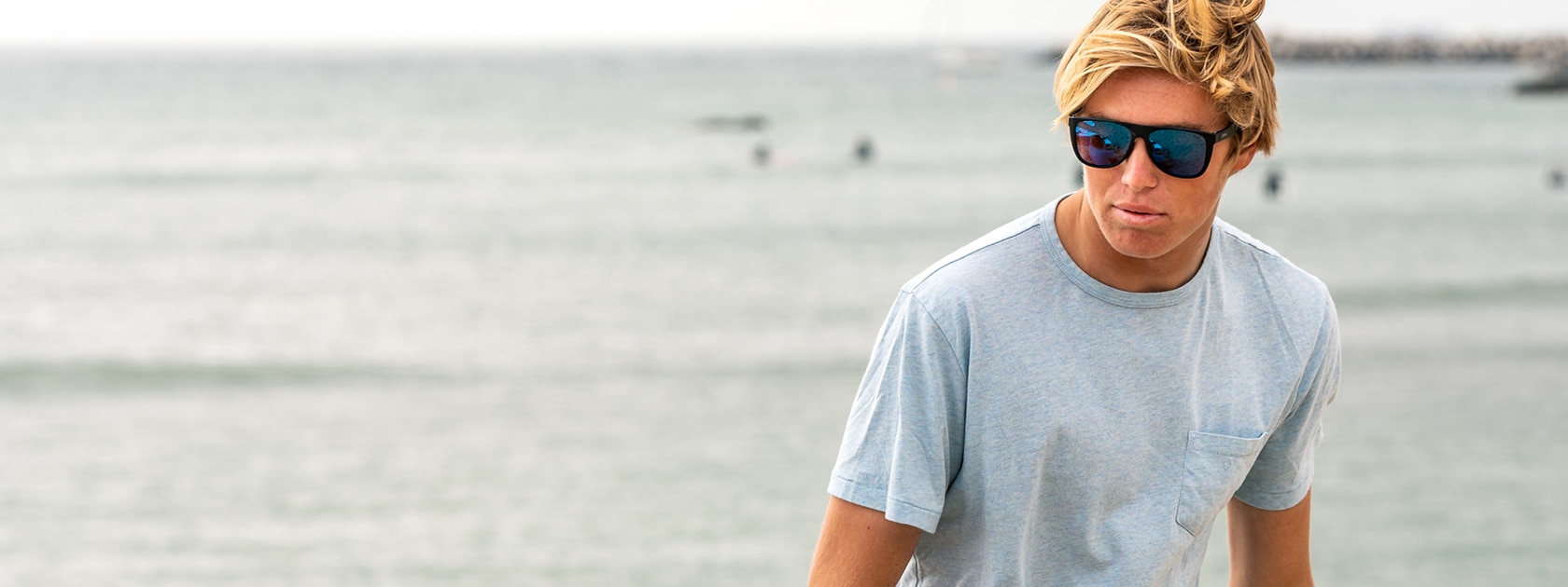 man wearing zeal minturn polarized sunglasses in front of the ocean