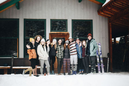 group of people in front of a ski lodge in the snow