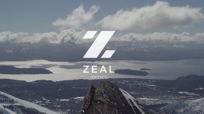 Zeal Optics logo over a mountain and river landscape