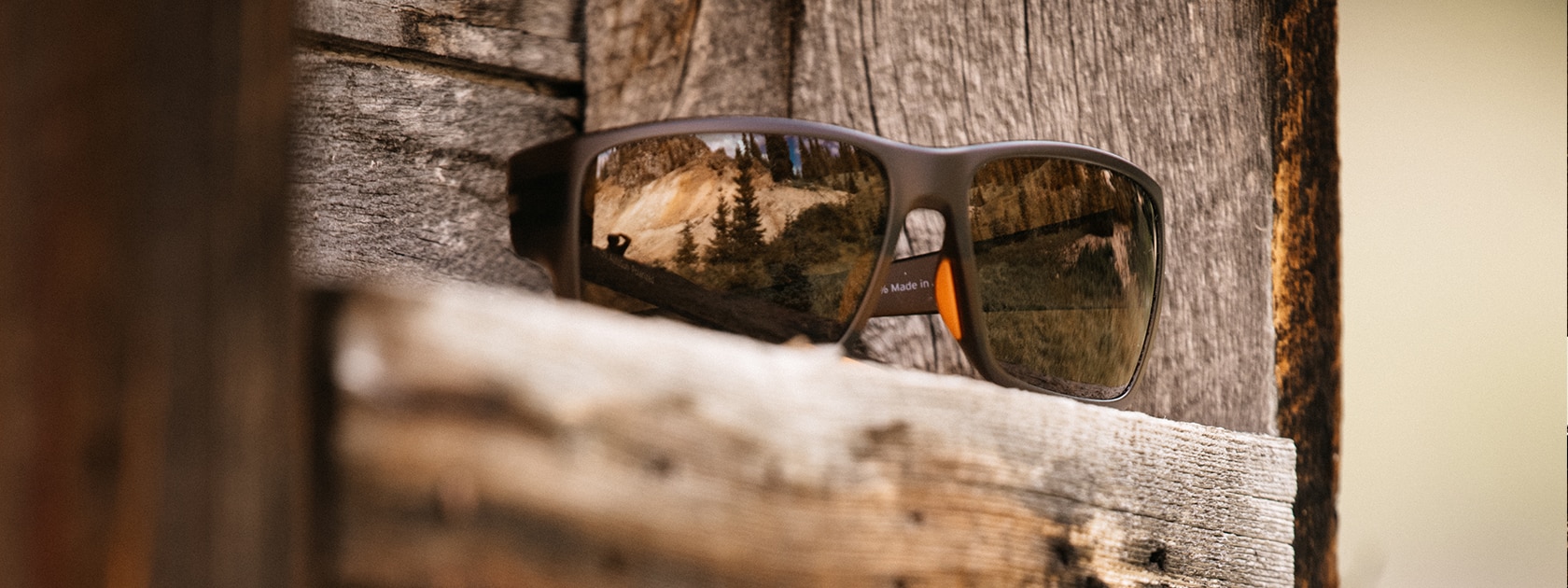 a pair of Zeal Optics sunglasses sitting on a wooden shelf