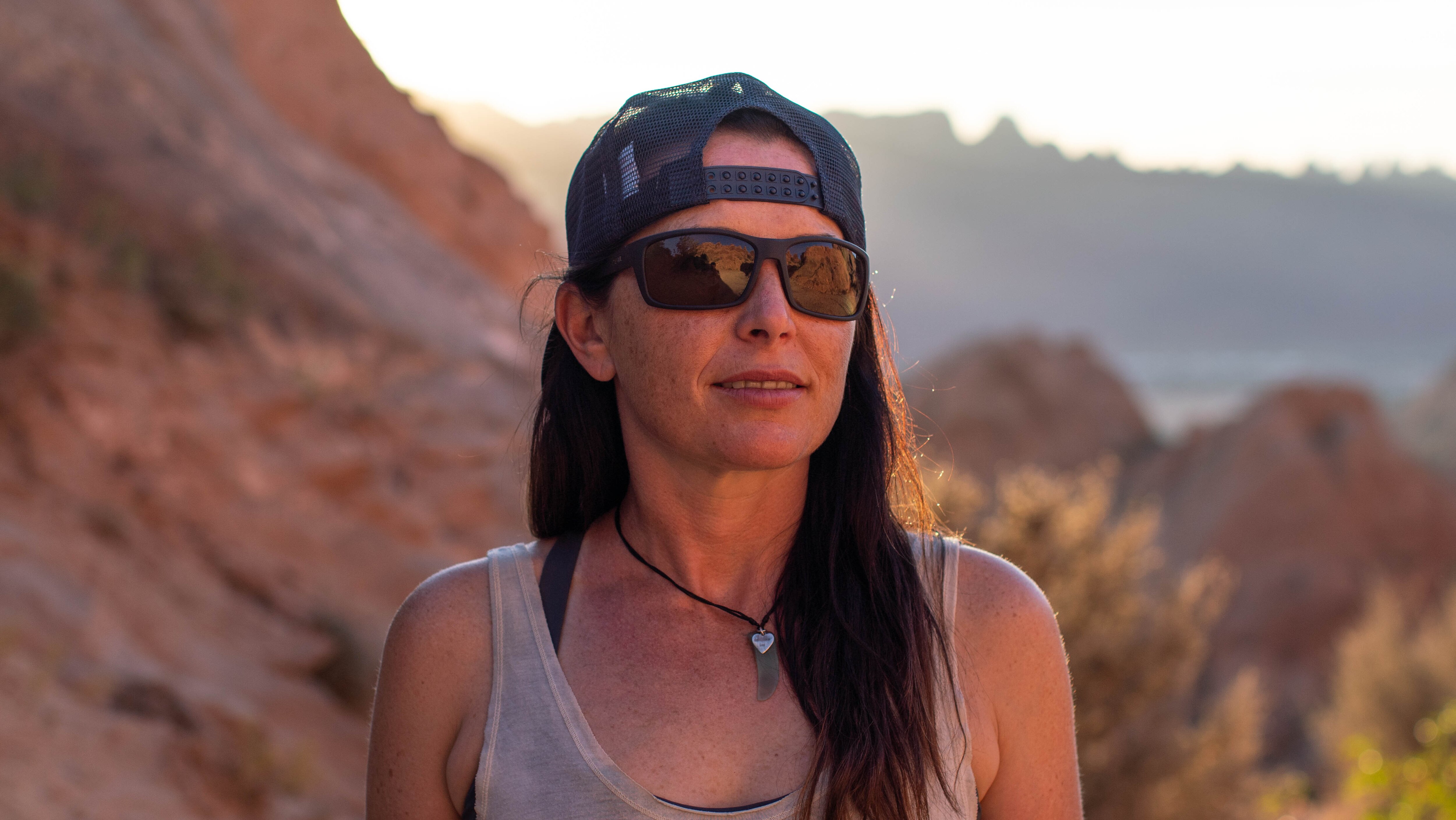 woman wearing zeal morrison auto sun photochromic polarized sunglasses with rocky moab background