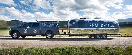 Zeal Optics truck and airstream trailer sitting in front of the mountains