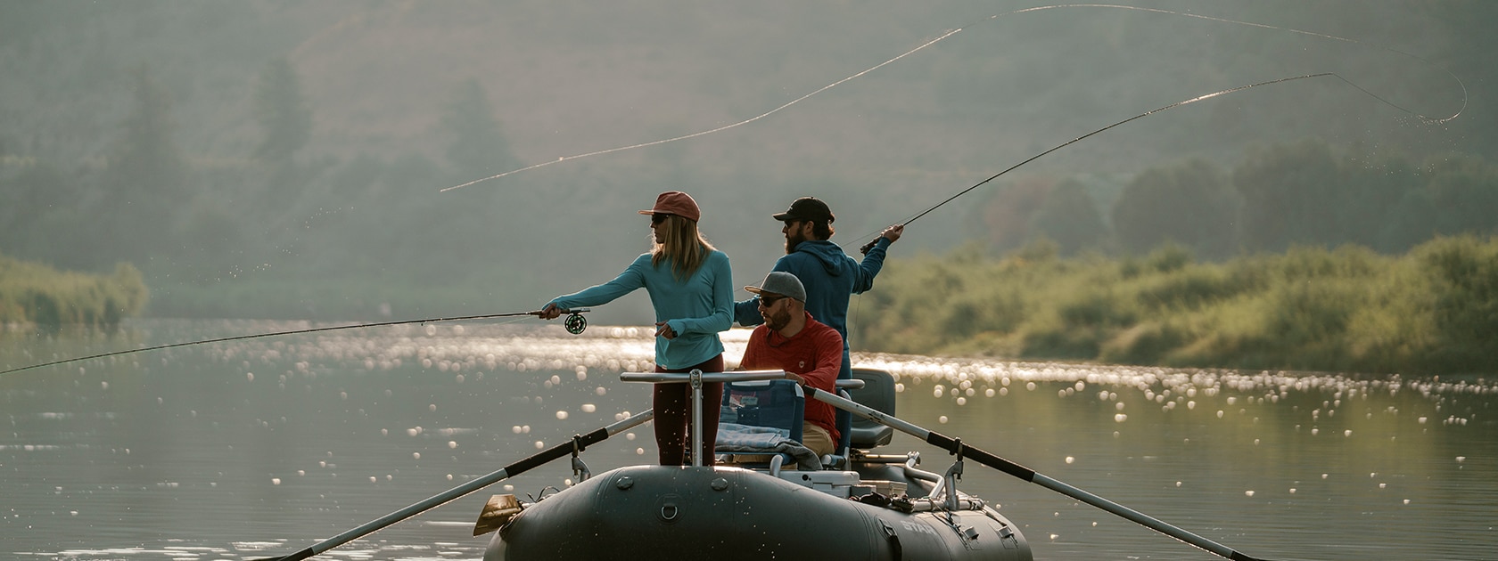 3 people wearing zeal polarized sunglasses fly fishing from a raft