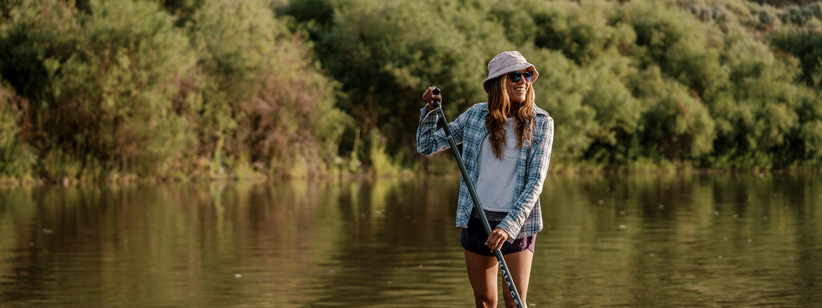 image of woman wearing zeal polarized sunglasses holding a paddle